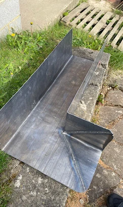 A man standing next to a metal ramp.