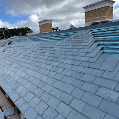 The roof of a building with a sky background.