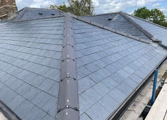The roof of a house with a metal shingled.